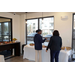 Two people talking at a buffet with assorted foods.