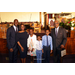 A family standing in front of the pulpit for a group photo. 